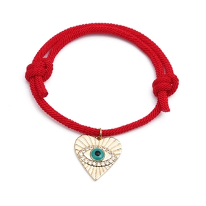Adjustable red cord bracelet with a gold-plated heart evil eye pendant and white zircons