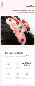 Detailed view of pink hair claw clip with colorful Christmas gift and snowflake patterns