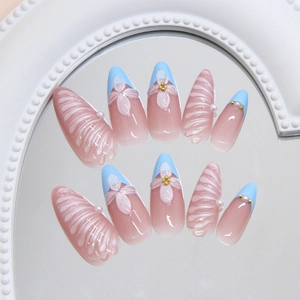 3D floral and pearl almond press-on nails with blue French tips and shell texture