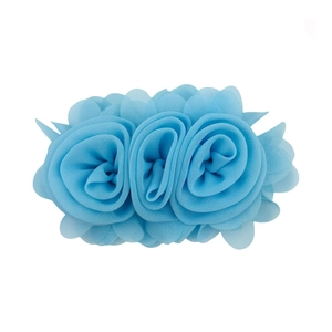 Detail of sky blue chiffon rose hair clip with triple layered fabric flowers design