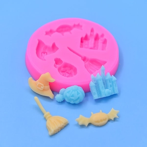 Pink silicone mold featuring Halloween shapes like pumpkin, castle, and bat for cake baking