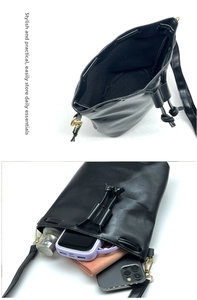 Detail of black drawstring bucket bag showing spacious interior for phone and wallet