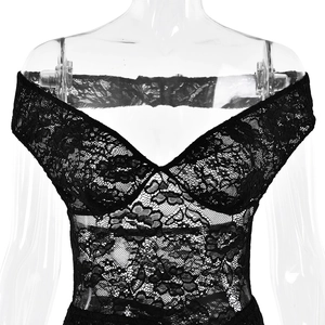 Detail of sheer black floral lace fabric and ruching on a backless sleeveless dress