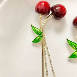 Elegant cherry tassel hair stick with deep red beads and green leaves on gold chain