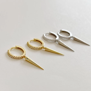 Detail of S925 silver hoop earrings with gold and silver spikes and pavé zircons