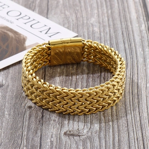Detailed view of wide gold wheat chain bracelet with three-row weave and magnetic clasp