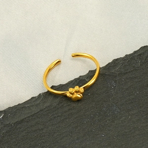 Detailed view of gold stainless steel adjustable ring with embossed cat paw prints