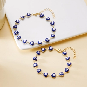 Detail of heart evil eye beads on gold-tone alloy anklet with lobster clasp closure