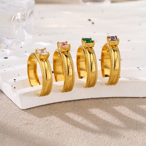 Detailed view of four gold-plated rings with colorful square-cut zircon stones