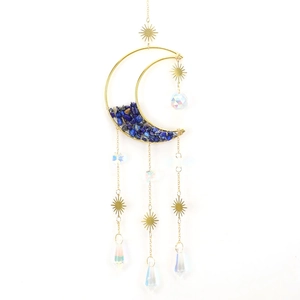 Detail of moon suncatcher with blue crystal stones and golden celestial charms