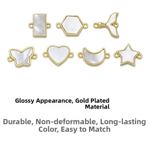 Detailed view of gold-plated charms with white shells in butterfly and star shapes