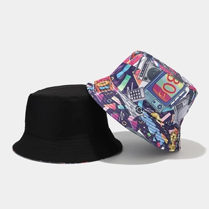 Detail of reversible bucket hat showing minimalist black side and retro 80s pop art print