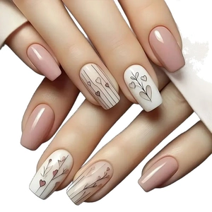 Nude pink and white press-on nails with minimalist heart stripes and vine designs
