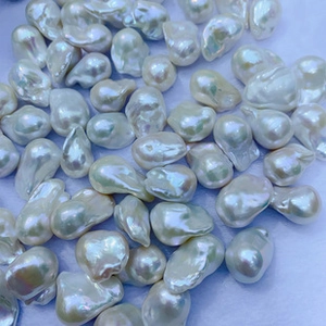 Macro shot of 4mm natural freshwater pearls showing high luster and white iridescence