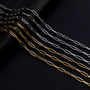 Polished gold and silver stainless steel paperclip chain necklaces on black silk
