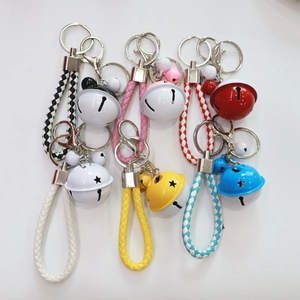 Cartoon bell keychains with colorful woven PU leather ropes in various bright candy shades