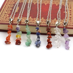 Detailed view of assorted natural agate and crystal stone pendants on fine metal chains