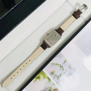 Detail showing the stainless steel back cover and brown leather strap of the GEDI watch