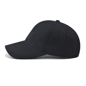 Detail view of the black cotton baseball cap showing side tonal letter embroidery and stitching