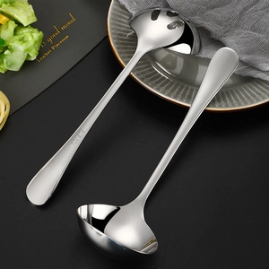 Polished SUS 304 gold stainless steel soup ladle and colander set on a black leather mat