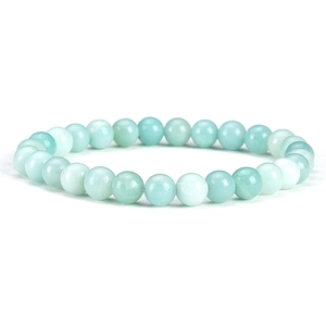 Detail view of 6mm light green natural stone beaded bracelet with elastic cord on white background