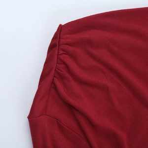 Close-up of pleated shoulder detail on a wine red vintage off-shoulder knit top