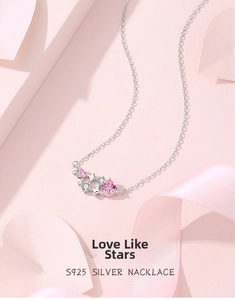 Detailed macro view of S925 silver necklace with pink heart gems and star pendants