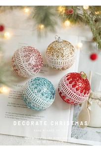 Detail of Christmas foam balls with glitter and white lace on festive background