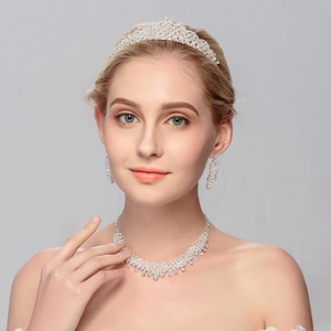 Elegant bridal jewelry set with sparkling crown necklace and earrings on model