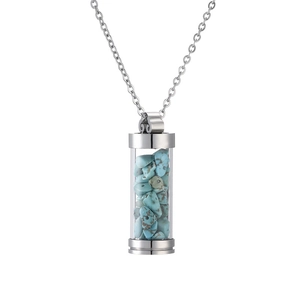 Detail of a silver cylindrical pendant necklace filled with vibrant blue crushed stones