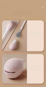 Detail of pink teardrop toilet brush base with drainage holes and gray silicone head