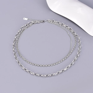 Detailed macro view of silver multi-layered stainless steel Cuban link chain necklaces