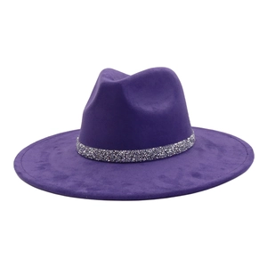 Detail of a dark purple wide brim fedora hat featuring a sparkling silver rhinestone band