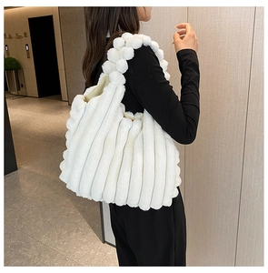 Detailed side view of white plush tote bag showing soft texture and large capacity