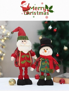 Detailed view of standing Santa and Snowman fabric dolls in a festive indoor setting