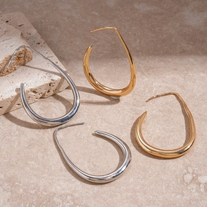 Minimalist hollow water drop earrings set in gold and silver finish on stone