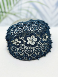 Detail of dark blue lace embroidery headband with faux pearls and sparkling rhinestones