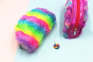 Detailed view of rainbow faux fur pencil case with shiny pink trim and silver zipper