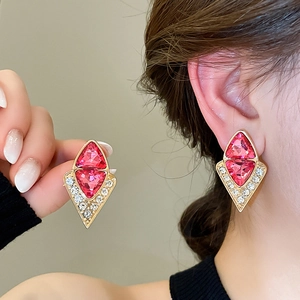Detailed view of vintage geometric drop earrings with pink crystals and micro-pavé diamonds