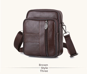 Detail view of brown pebbled leather bag with premium metal zippers and fabric strap