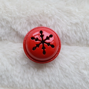 Detail of red hollowed-out star bell with snowflake patterns for Christmas tree decoration