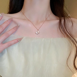 Rose gold butterfly necklace with zircon and shell inlay shown on female neck