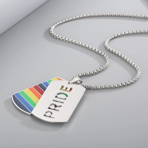 Detailed shot of double layer military dog tag with PRIDE cutout and rainbow stripes