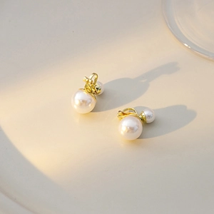 French luxury pearl clip earrings in gold finish with elegant double pearl design