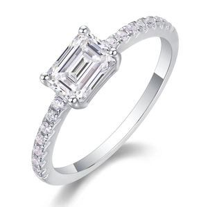 Macro shot of rectangular moissanite center stone on sterling silver ring with side stones