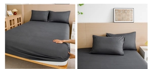 Detail of dark grey fitted sheet showing high elastic edges and matching pillowcase