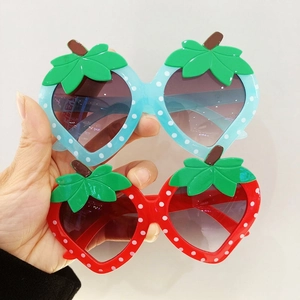 Cute strawberry-shaped children sunglasses with white polka dots and green leaf accents