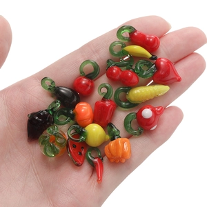 Miniature glass fruit and vegetable charms for DIY jewelry making held in palm