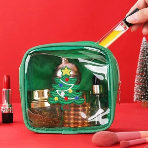 Detailed view of green chenille Christmas tree pouch storing cosmetics and skincare