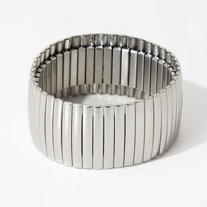 Macro view of silver elastic stainless steel bracelet with textured ribbed metal links